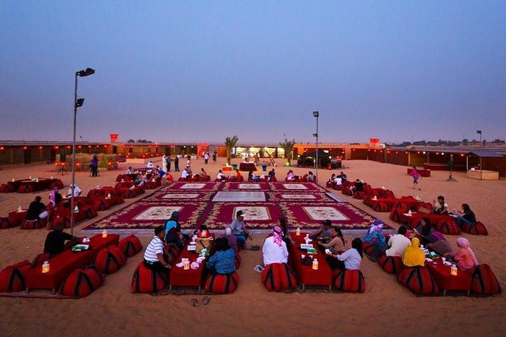 Experience the magic of the desert under a starlit sky savor delicious Middle Eastern cuisine and enjoy captivating performances creating unforgettable moments in Dubai's serene landscape.